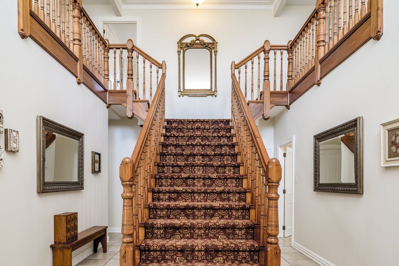 big-wooden-staircase-with-vintage-carpet-inside-apartment-with-white-walls_181624-19451.jpg