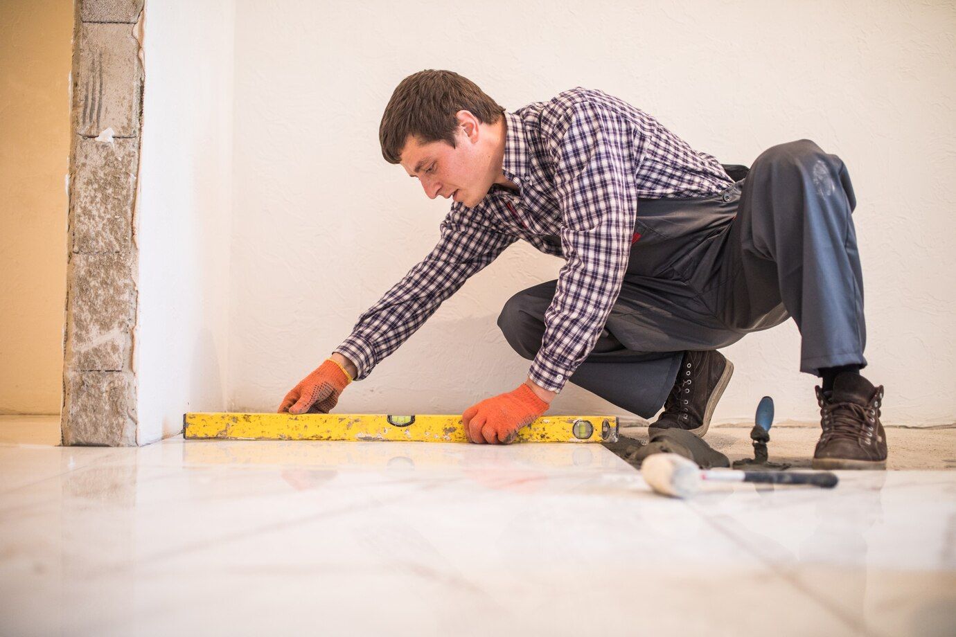 home-tile-improvement-handyman-with-level-laying-down-tile-floor_231208-6795.jpg