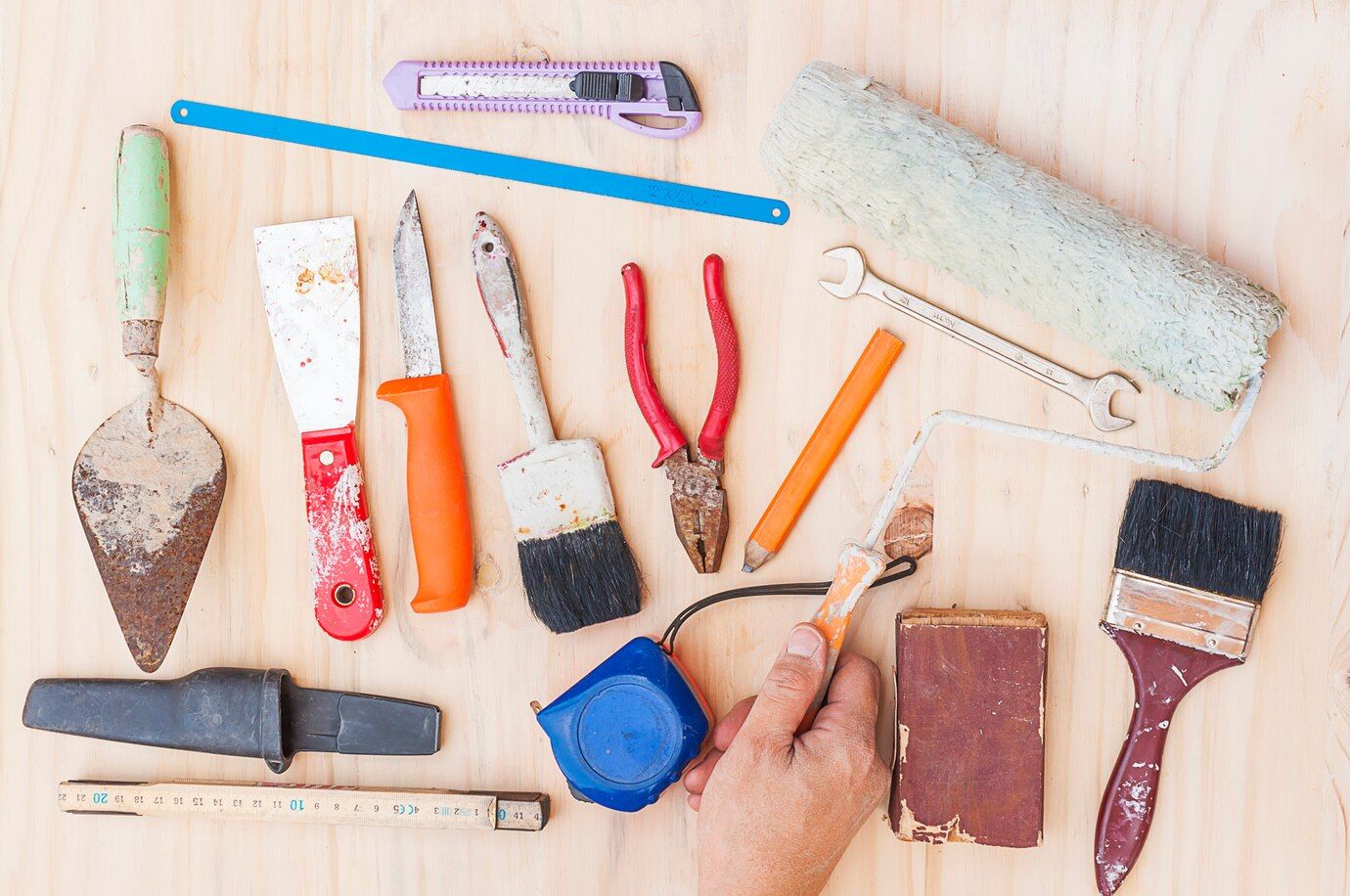 old-construction-hand-tool-set-with-worker-hand-white-wooden-background_1150-6089.jpg